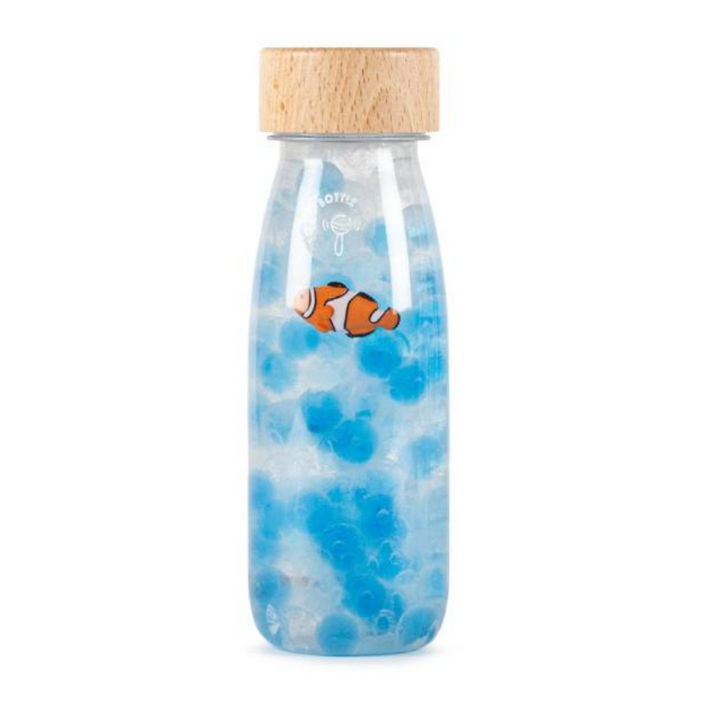 A picture of a Petit Boum Fish Sound Sensory Bottle, a clown fish swimming around a blue sea styled sensory bottle