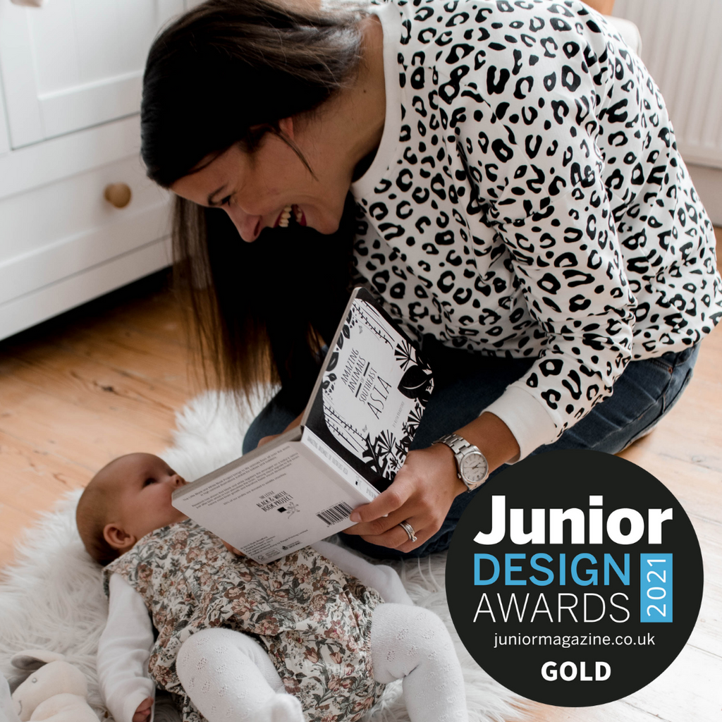 A mum reading the black and white board book to her newborn baby from the 0-3 month baby's first year sensory play subscription