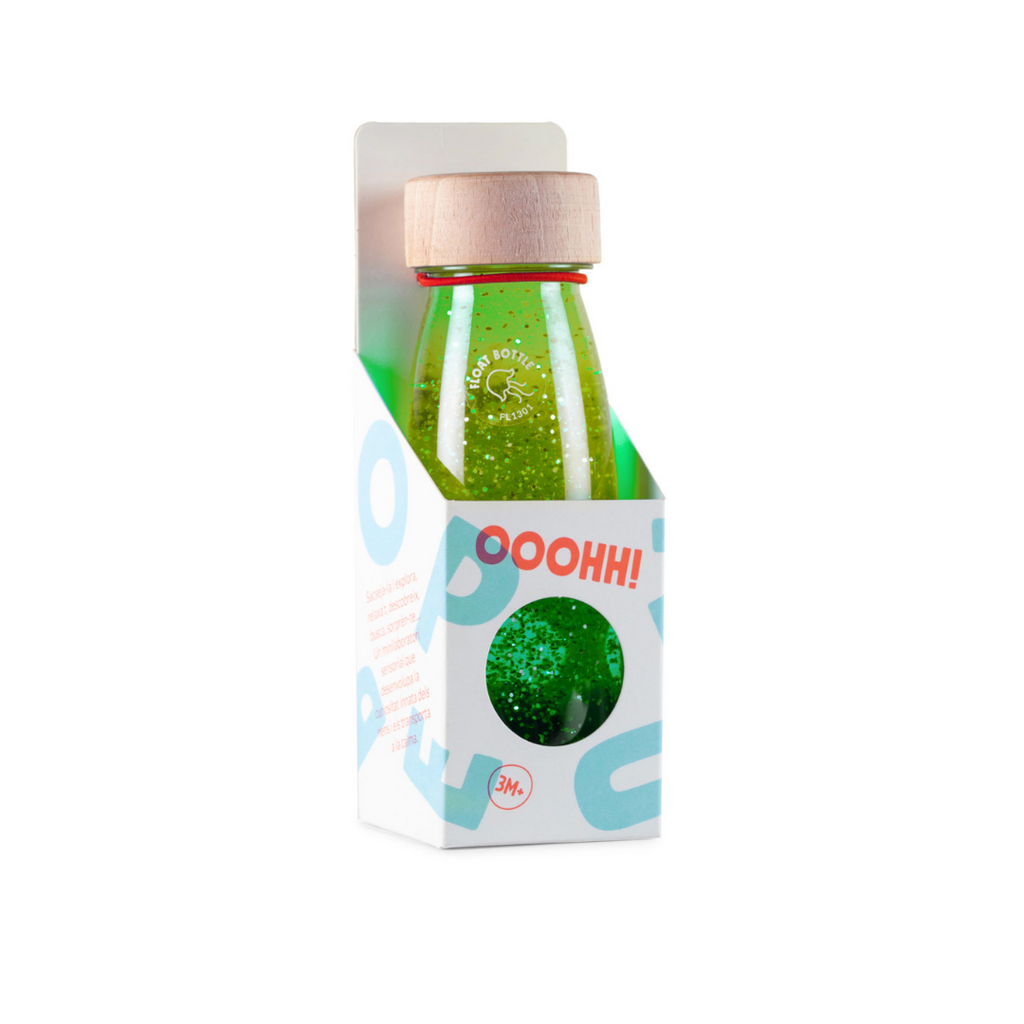 A Petit Boum grenn sensory float bottle in it's packaging.